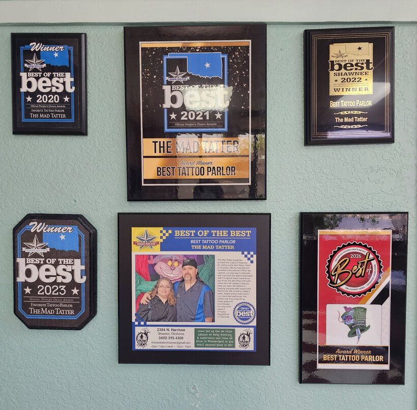 Best of the Best award plaques on the wall at The Mad Tatter
